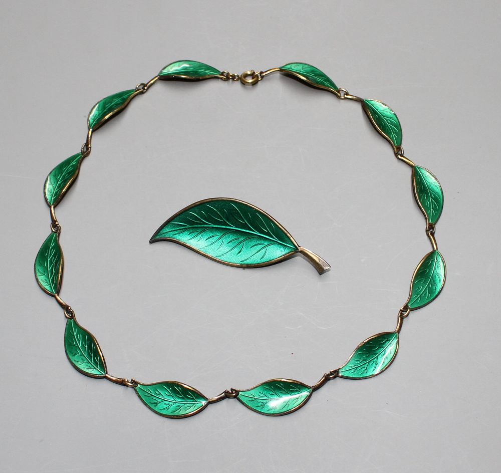A Norwegian David Andersen 925S and green enamel leaf necklace and one other leaf brooch.
